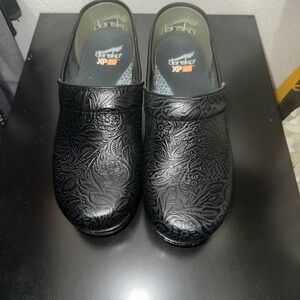 Dansko Black Floral Embossed Clogs